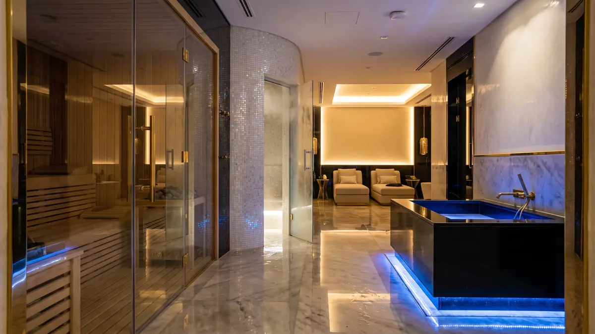 Villa wellness suite corridor with glass sauna, steam room and cold plunge in a Dubai basement